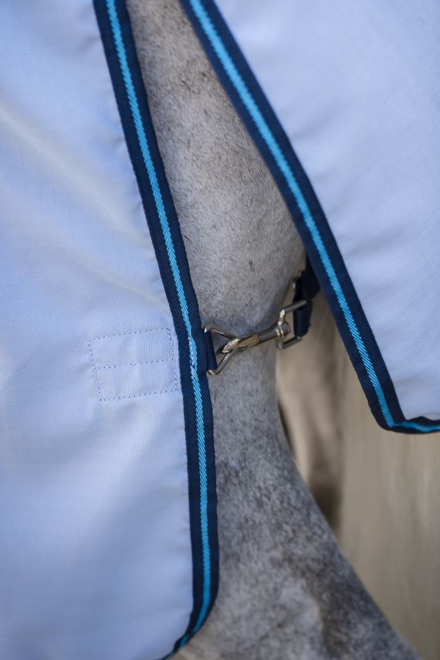 Nahaufnahme des Brustverschlusses der Horseware Amigo Ripstop Hoody in Azurblau mit navyfarbenem Gurtband am Pferd.